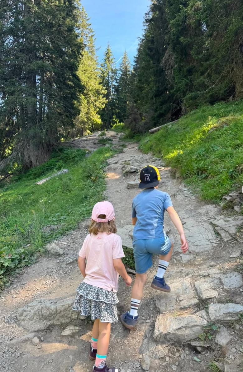 Emilie's two children walking up a woodland trail